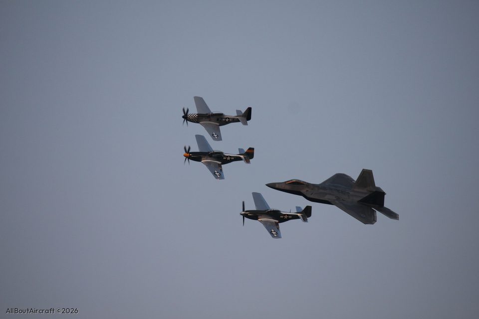 Three P-51 Mustangs and an F-22