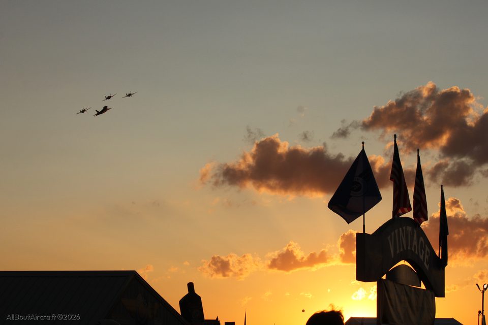 Four-ship over the Vintage hangar at sunset