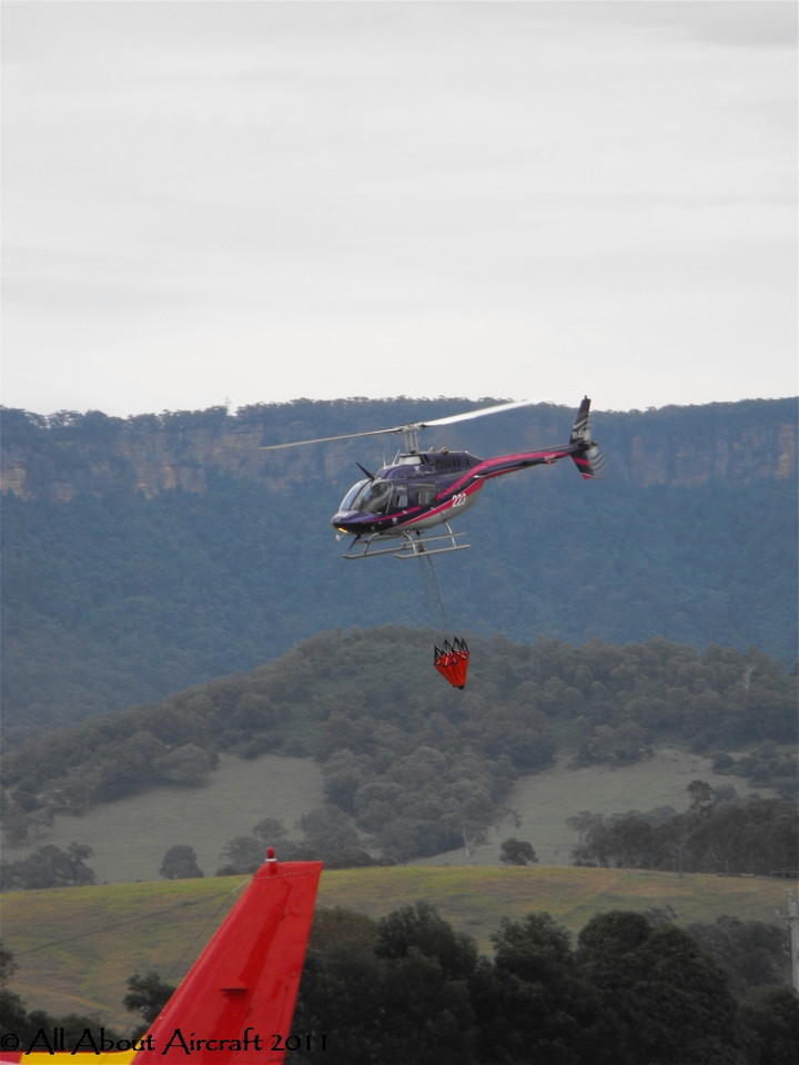 Bell 206 223 with a fire bucket