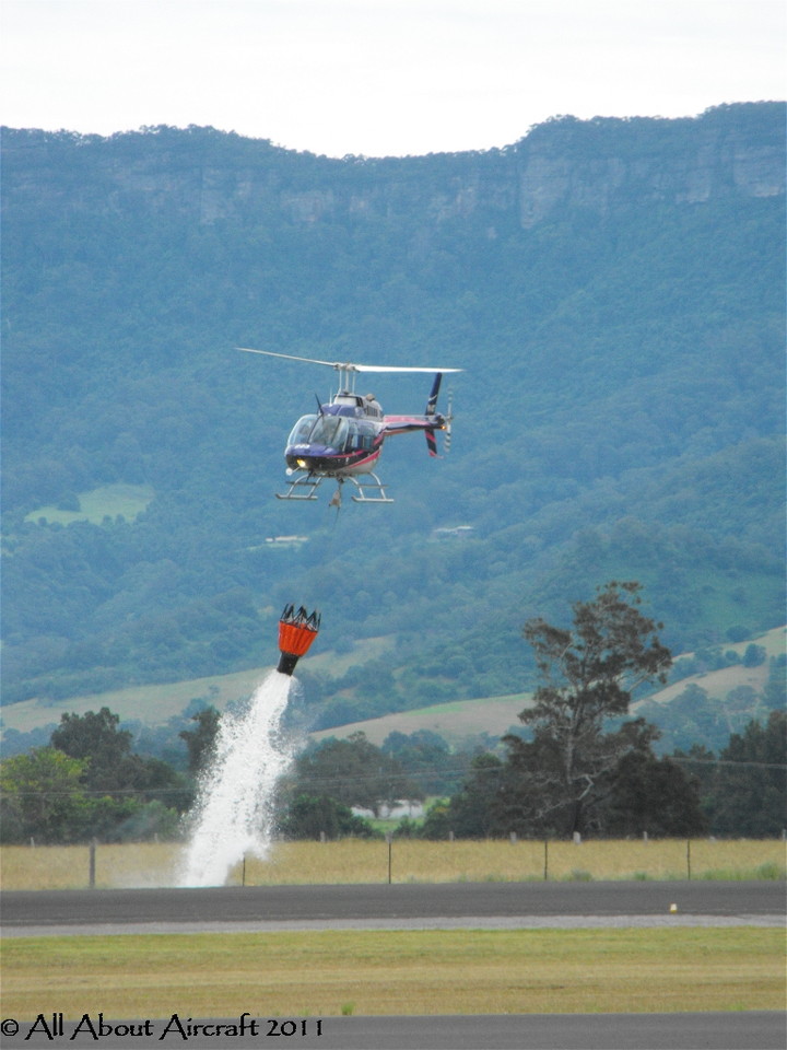 Bell 206 223 dropping a fire bucket